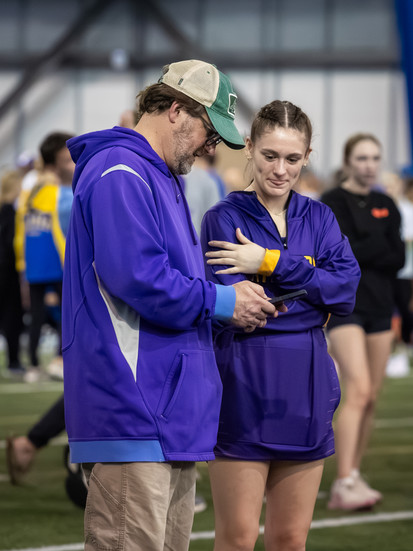 Katie Flemming talks with her pole vault coach.