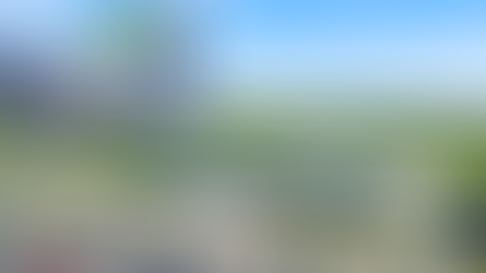 Watertown Regional Airport with solar panels, logo for VALE Clean Technology. Parking lot and green fields visible under a clear blue sky.