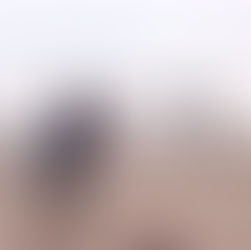 Father and young son running together toward the water symbolizing trust, connection, and love in motion.