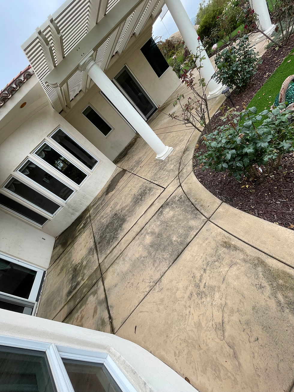 Before cleaning: Concrete surface covered in stains, dirt, and grime, in need of professional cleaning services.