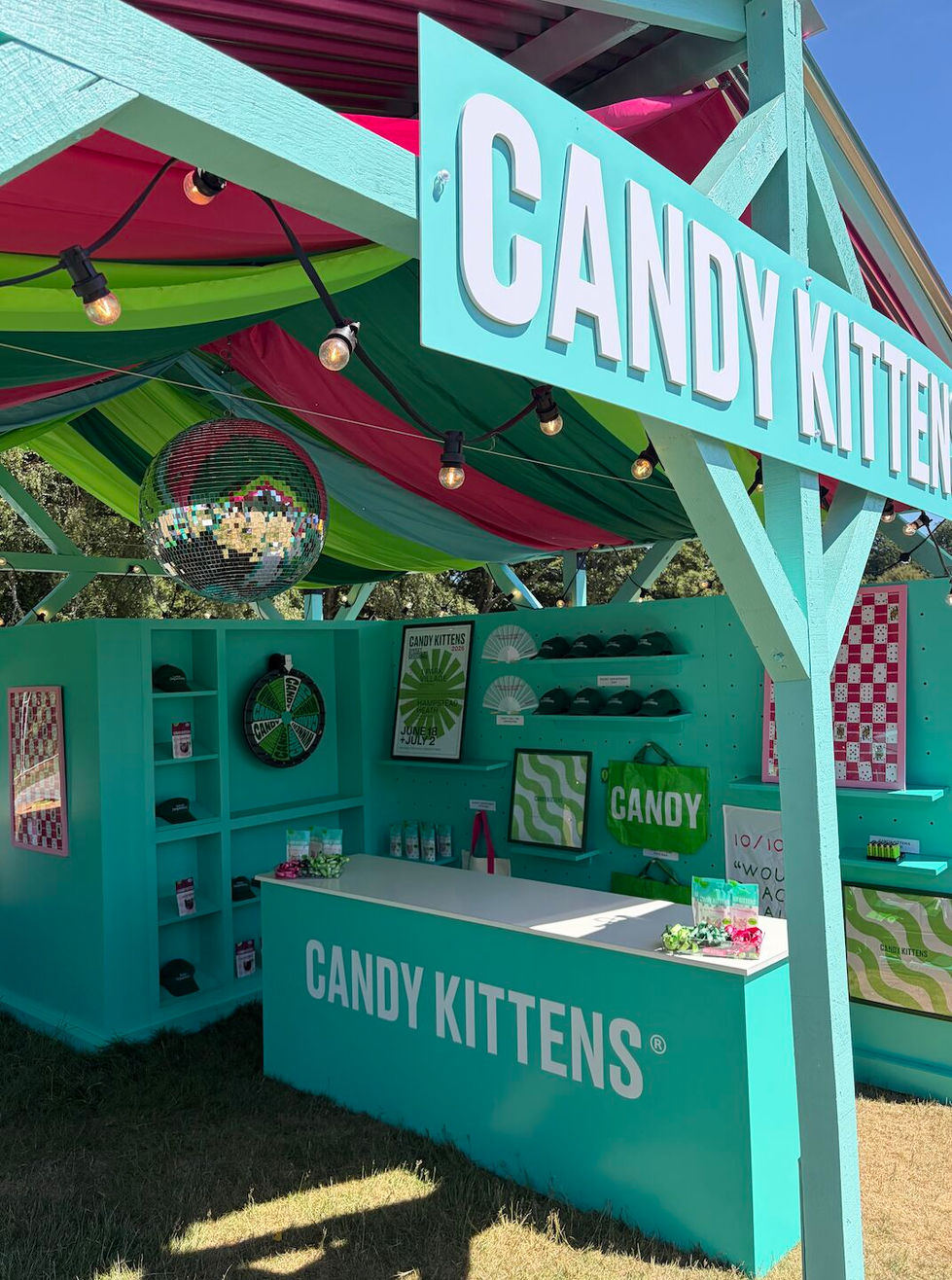 Colorful Candy Kittens booth with vibrant decorations.