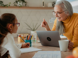 Grandmother helping granddaughter with school project.