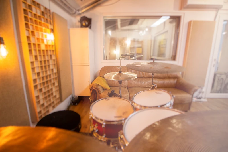 Schüler übt Schlagzeug zuhause mit Online-Kurs: Auf dem Bildschirm läuft ein kurzes Übungsvideo aus dem Buch „Born to be a Drumstar“ mit animierten Noten. Der Groove wird vorgespielt, während die Noten synchron mitlaufen, damit Timing, Rhythmusgefühl und Notenlesen verbessert werden. Der Kurs hilft Schlagzeugschülern, Übungen korrekt und sicher zuhause zu üben.