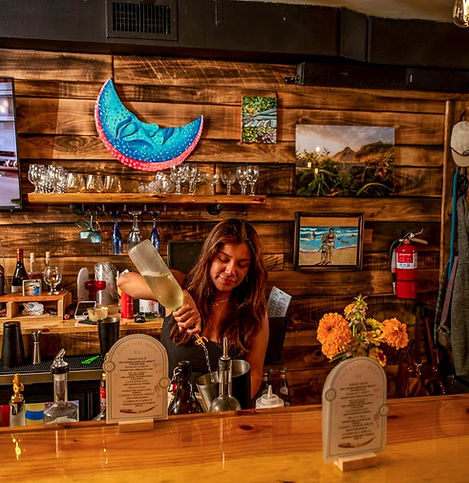Jharixa behind the bar of Huanchaco making a cocktail