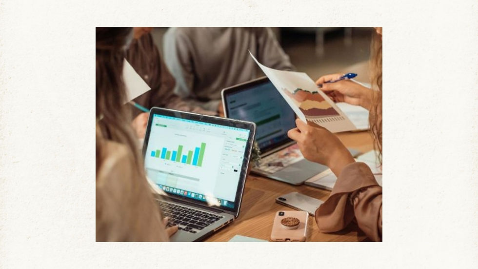 Modern work setting illustrating the evolution of laptops, with people using advanced laptops to analyze charts and graphs, highlighting trends in productivity and collaboration.