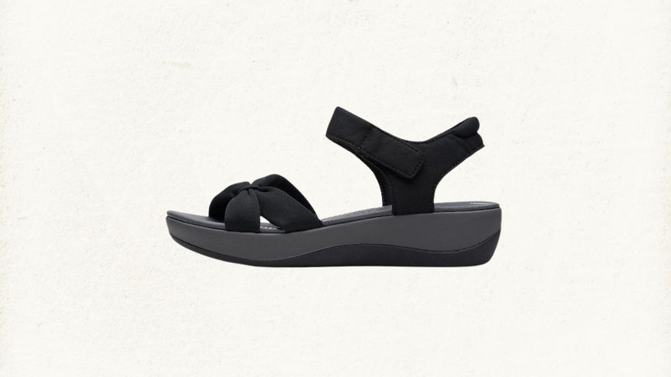 Clarks Arla Shore Flat Sandals in black, displayed on a clean white background. Designed with lightweight Cloudsteppers cushioning and an adjustable fabric strap for all-day summer comfort