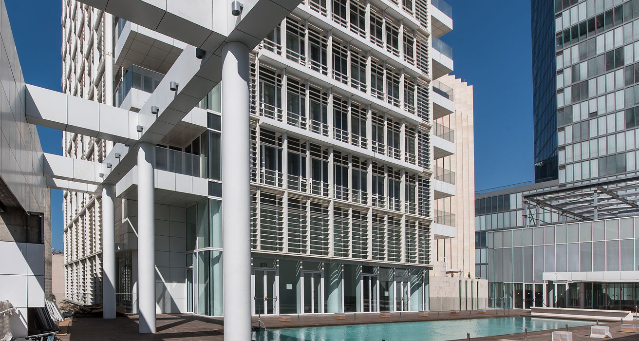 Modern white residential towers, reflecting pool