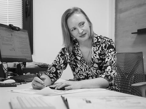 Architect reviewing blueprints at her desk