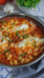 Close-up view of a colorful dish with beans and eggs