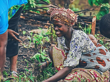 An African woman admiring her harvest