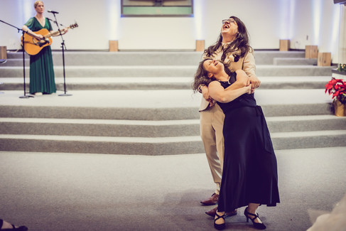 the groom and his mother laugh as he dips her at the end of the song