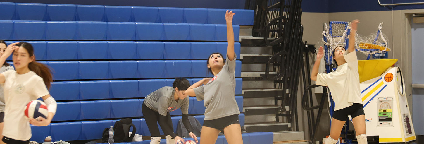 Players practicing serves in volleyball.