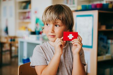Child holding a lego piece