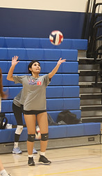 Girl Club Team practicing volleyball serves