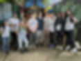 A group of eight Young Leaders for Peace students alongside four instructors in front of a mural in Costa Rica. 