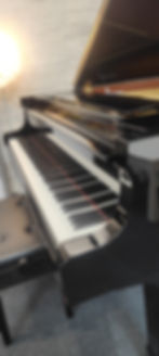 Close-up of Yamaha C3 Grand Piano keyboard and Yamaha logo – pristine keys and polished finish, reconditioned in Japan