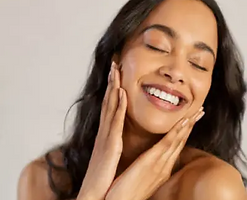 Smiling olive skined woman with wavey black hair