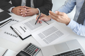 Two men at desk going over life insurance policy