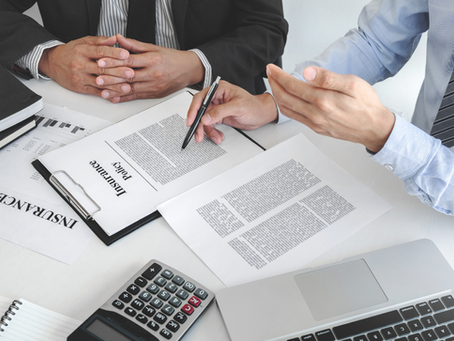 Two men at desk going over life insurance policy