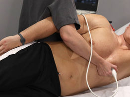 A female clinician undertaking and Echocardiogram