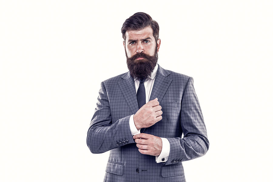 serious man in a grey check pattern suit