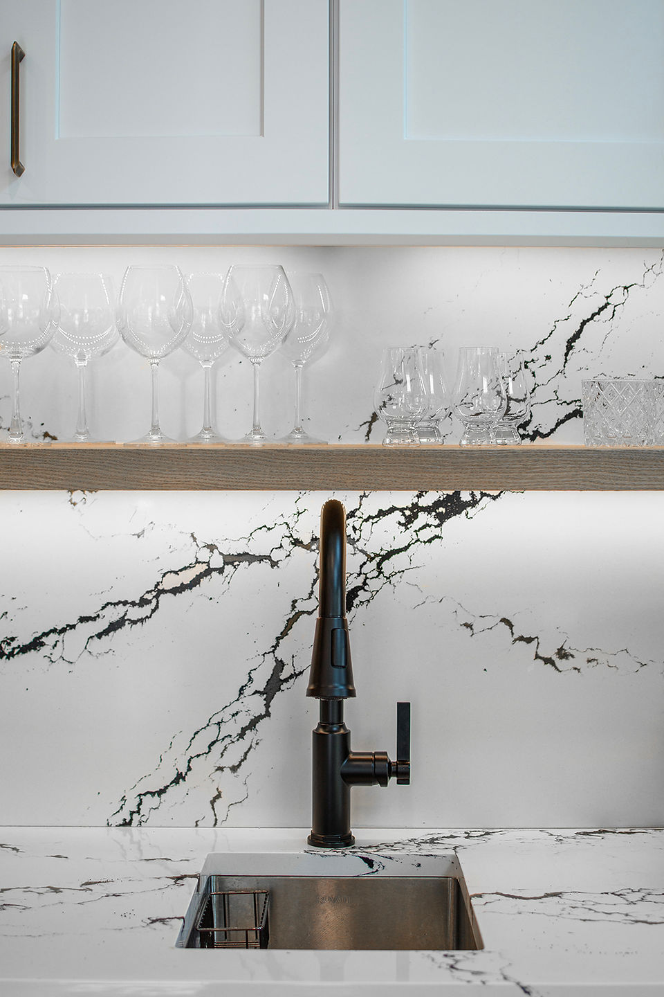 small sink in marble with black faucet photos by Dave Daniels Photography
