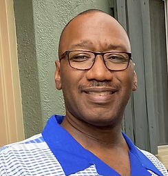 Headshot of smiling man in glasses