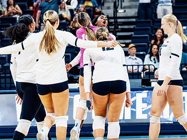 USD Volleyball team celebrating a point during game