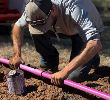Tech making repairs on an aerobic septic system