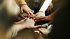 closeup-diverse-people-joining-their-hands.jpg