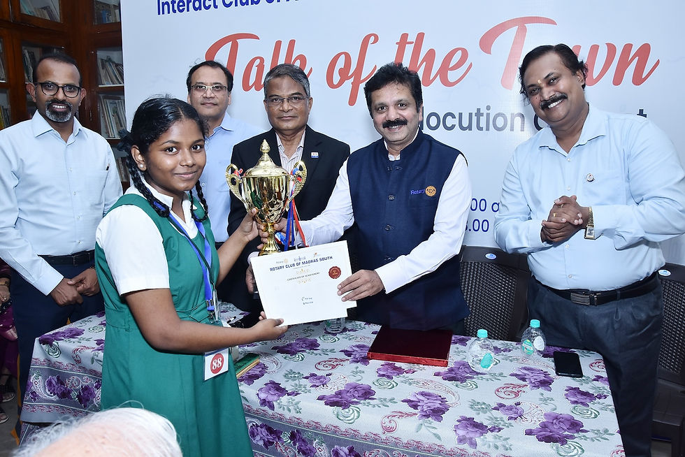 A Anjali, class 9 student of Sacred Heart Girls High School (Tamil Medium) receives the winners trophy for English Elocuation from District Governor N S Saravanan.