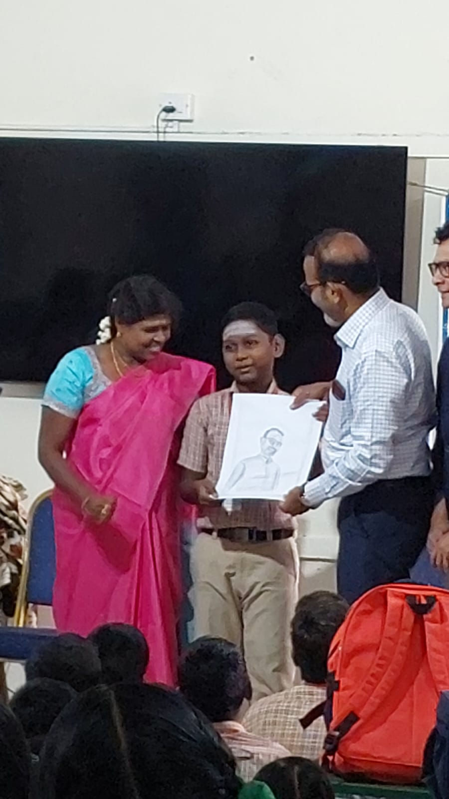 Thanking from the heart: A student of Arumbakkam Govt school presents his drawing of our Club Presidnet during the valedictory funtion of Spoken English course.