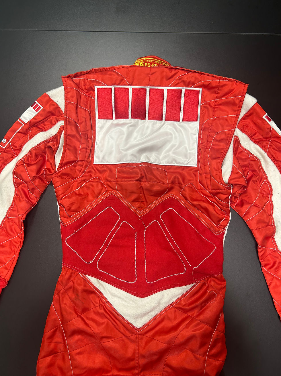 Tuta da corsa Ferrari rossa con dettagli bianchi sul retro