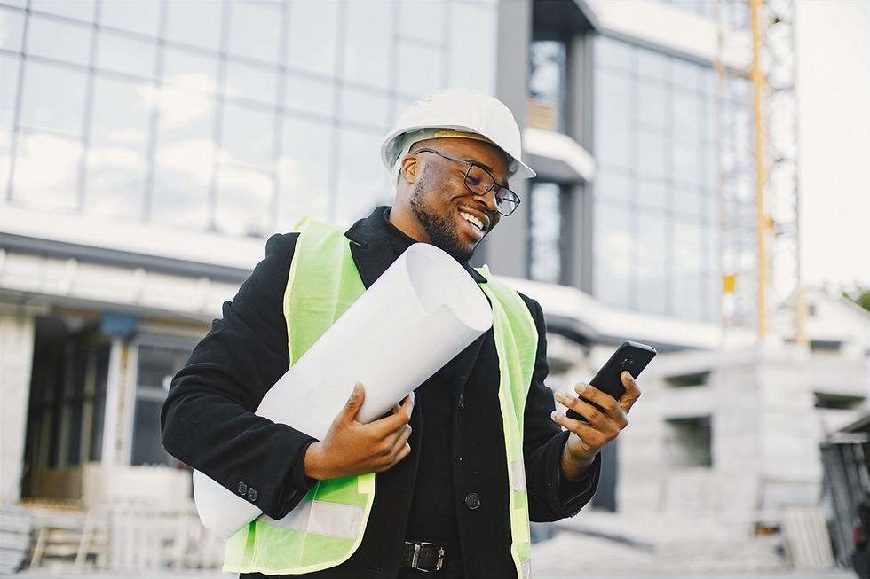 young-black-race-man-with-blueprint-standing-near-glass-building