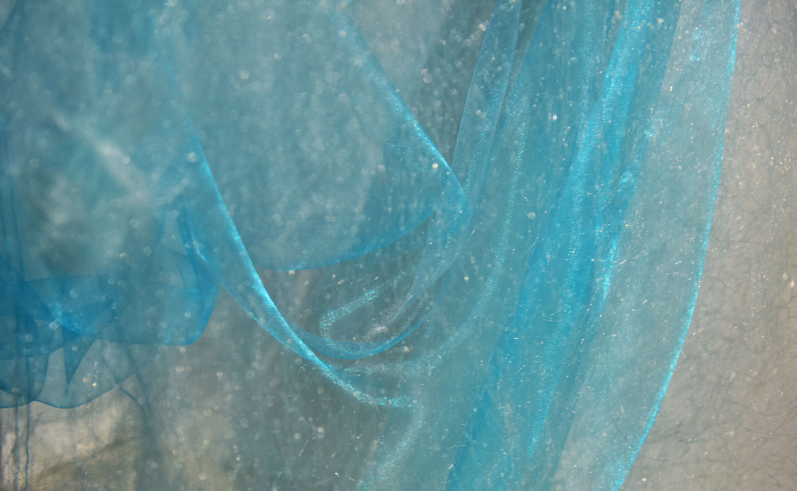 Photo of the translucent blue cloth which is slightly sparkling.