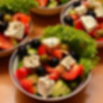 Fresh Greek salad bowl with feta cheese cubes, chopped tomatoes, cucumbers, peppers, and black olives, illustrating a healthy low-carb meal in a vegetarian diet for diabetes.