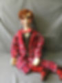 Ventriloquist doll in a red suit.