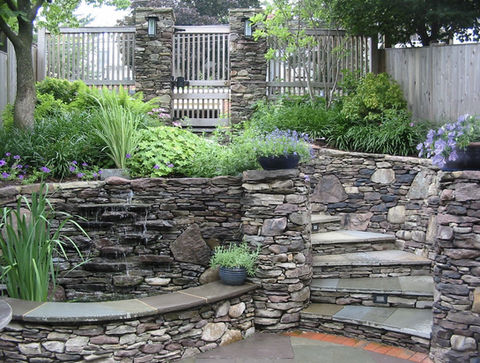 Woodley Park garden with seep wall fountain, circular patio, and stone stairs, Washington DC