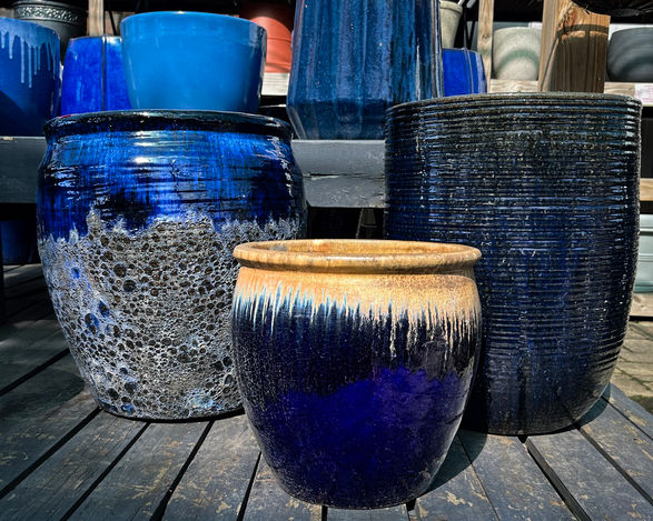 A mixed group of textured, blue ceramic pots for a container garden in Washington DC