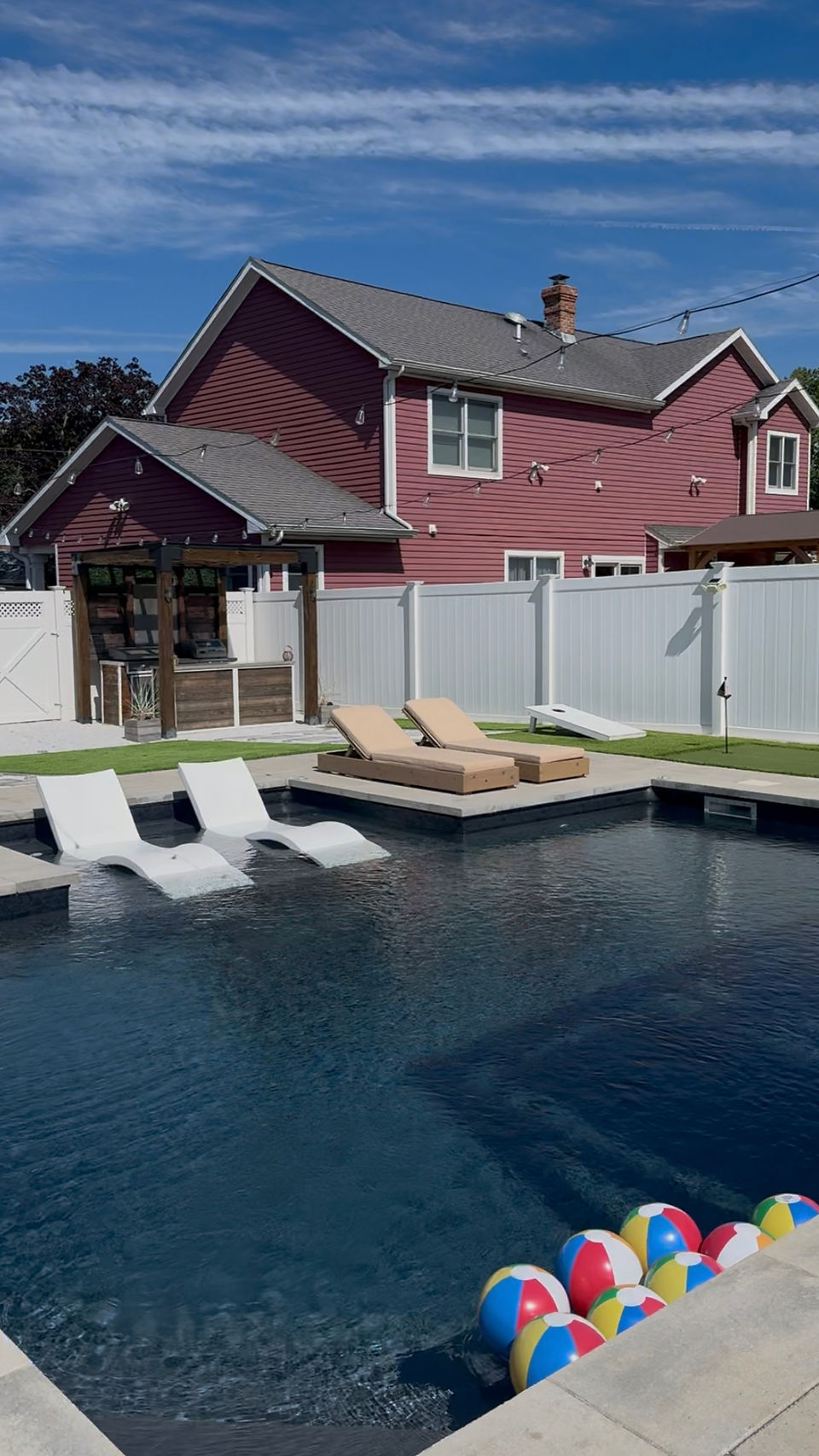 Daytime view of loungers next to a pool.