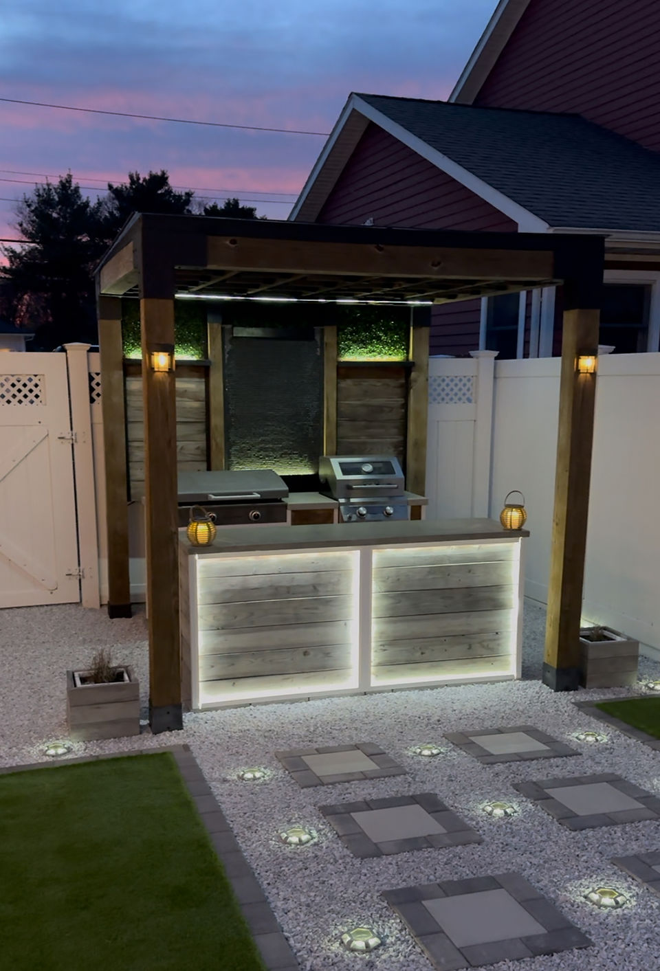 Nighting photo of outdoor kitchen with concrete countertops.