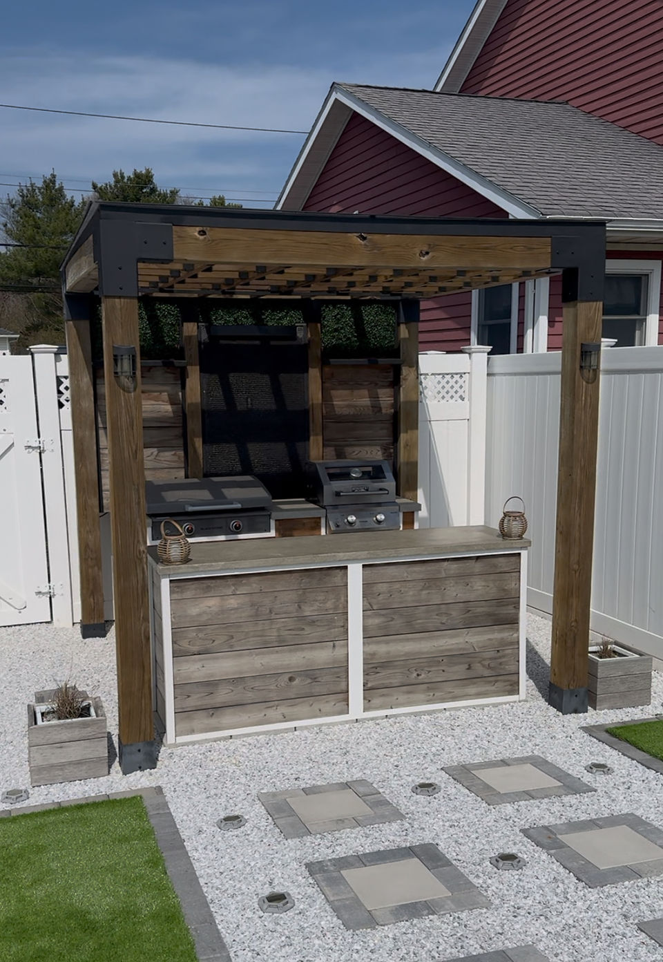 Daytime photo of outdoor kitchen with concrete countertops.