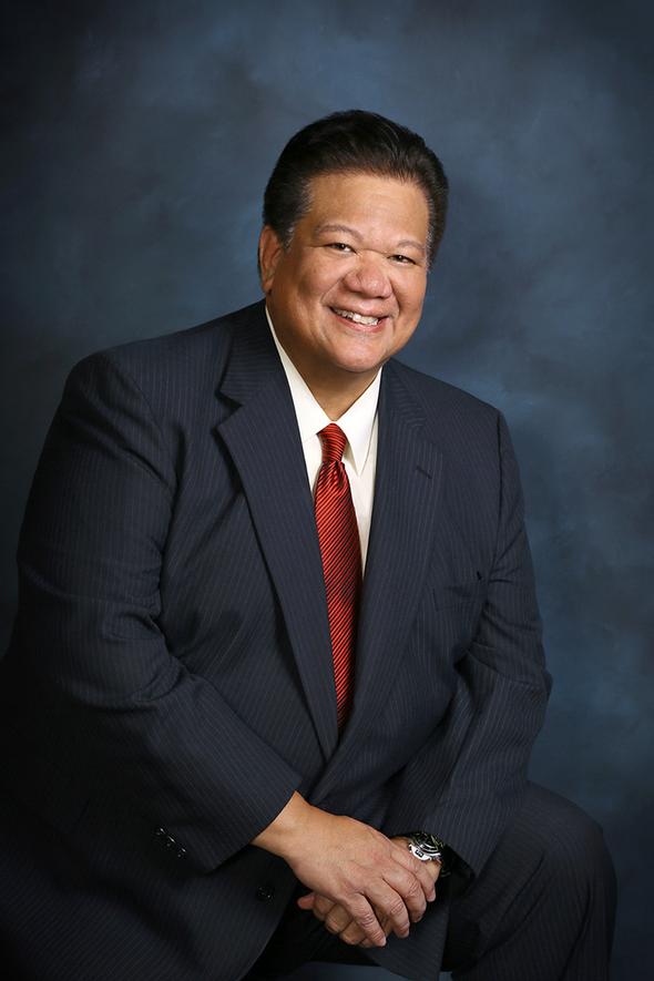 Smiling man in suit and red tie