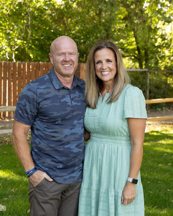 Two smiling staff members