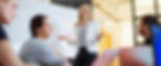 Woman presenting to colleagues in a meeting