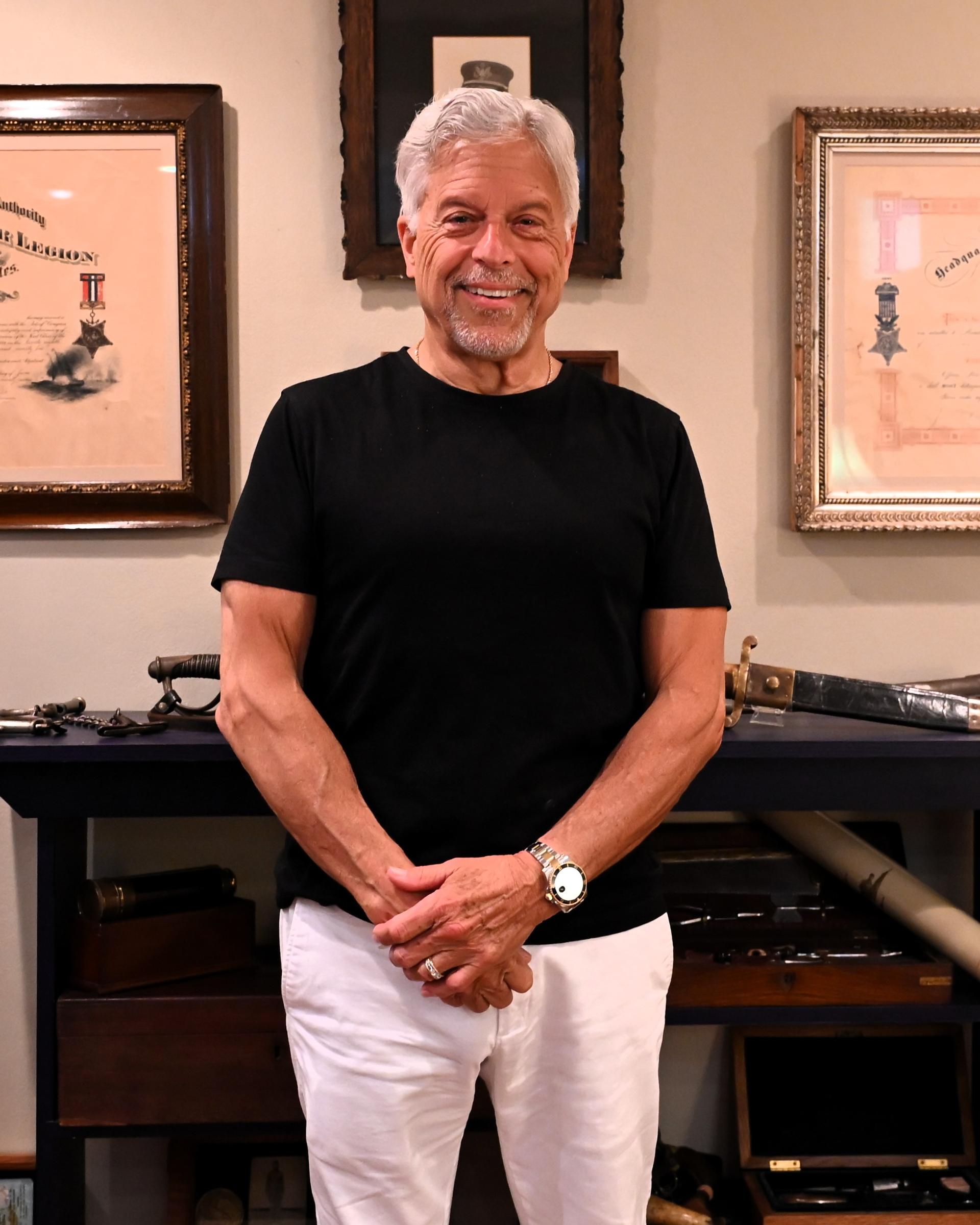 Smiling senior man standing in a client profile setting