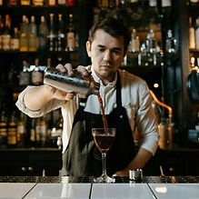 A bartender making a cocktail in an elegant bar. ESL lesson for beginners
