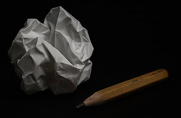 Crumbled up paper and blunt pencil symbolizing metal fatigue