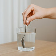 Hand Stirring Remedy into Water – Gentle Gemotherapy Preparation for Detox Support