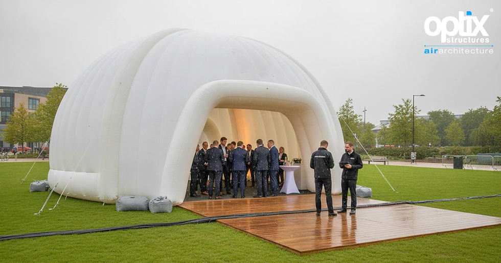 10m Optix inflatable Dome protecting a professionally managed corporate event during light rain.